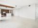 Spacious living room with tile floors, recessed lighting, and a modern kitchen at 111 Golden Gate Pt # 403, Sarasota, FL 34236