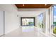 Bright living room featuring tile floors, recessed lighting, and sliding doors to a balcony at 111 Golden Gate Pt # 403, Sarasota, FL 34236