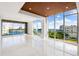 Bright living room featuring tile floors, recessed lighting, and panoramic marina views at 111 Golden Gate Pt # 403, Sarasota, FL 34236