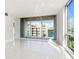 Bright living room with floor to ceiling windows and water views at 111 Golden Gate Pt # 403, Sarasota, FL 34236