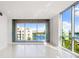 Bright living room featuring floor-to-ceiling windows and waterfront views at 111 Golden Gate Pt # 403, Sarasota, FL 34236