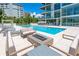 Relaxing pool area with fire pit and comfortable seating at 111 Golden Gate Pt # 403, Sarasota, FL 34236