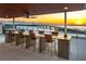 Rooftop deck featuring a long counter with seating and stunning sunset views of the bay and bridge at 111 Golden Gate Pt # 403, Sarasota, FL 34236