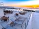 Rooftop deck with lounge chairs, tables, and bay views at 111 Golden Gate Pt # 403, Sarasota, FL 34236