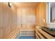 Inviting wooden sauna with benches and traditional sauna bucket at 111 Golden Gate Pt # 403, Sarasota, FL 34236