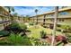 Community courtyard with lush landscaping and a seating area at 11485 Oakhurst Rd # 200-220, Largo, FL 33774