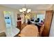 Bright dining area with wood table and chandelier at 11485 Oakhurst Rd # 200-220, Largo, FL 33774