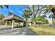 Exterior view of building with covered entrance at 11485 Oakhurst Rd # 200-220, Largo, FL 33774