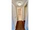 Clean hallway with linen closets and wood-look floors at 11485 Oakhurst Rd # 200-220, Largo, FL 33774