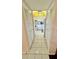 Hallway with white closet doors leading to the kitchen at 11485 Oakhurst Rd # 200-220, Largo, FL 33774