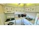 Bright kitchen with white cabinets and appliances at 11485 Oakhurst Rd # 200-220, Largo, FL 33774