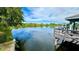 Scenic lake view with a gazebo and dock at 11485 Oakhurst Rd # 200-220, Largo, FL 33774