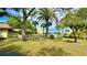 Landscaped lawn with mature trees and a flag at 11485 Oakhurst Rd # 200-220, Largo, FL 33774