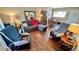 Bright living room with comfy seating and wood-look floors at 11485 Oakhurst Rd # 200-220, Largo, FL 33774