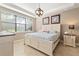 Main bedroom with king-size bed, nightstands and large window at 12253 Marsh Pointe Rd, Sarasota, FL 34238