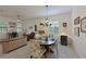 Bright dining area with a rustic wooden table, chandelier, and seating for four at 13024 Indigo Way, Bradenton, FL 34211