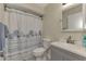 Bathroom with gray vanity, seashell shower curtain, and a mirror at 13479 Newport Ave, Port Charlotte, FL 33981