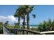 Scenic boardwalk path offering convenient beach access with palm trees at 13479 Newport Ave, Port Charlotte, FL 33981