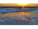 Stunning sunset view over ocean waves gently lapping on sandy beach at 13479 Newport Ave, Port Charlotte, FL 33981