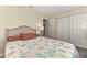 Bedroom with wicker headboard, coral bedding, and a large closet at 13479 Newport Ave, Port Charlotte, FL 33981