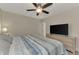 Bright bedroom with ceiling fan and TV at 13479 Newport Ave, Port Charlotte, FL 33981