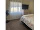 Bedroom with a dresser, large window, and patterned bedding at 13479 Newport Ave, Port Charlotte, FL 33981