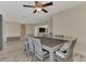 Spacious dining area with a large table, wicker chairs, and views into the living room at 13479 Newport Ave, Port Charlotte, FL 33981