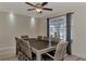 Bright dining room with large table and seating for eight, featuring a ceiling fan and large window at 13479 Newport Ave, Port Charlotte, FL 33981