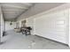 Attached garage with a white door and a spacious covered porch at 13479 Newport Ave, Port Charlotte, FL 33981