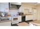 Bright eat-in kitchen, featuring white cabinetry, stainless steel appliances, and ample counter space at 13479 Newport Ave, Port Charlotte, FL 33981