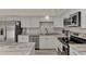Renovated kitchen, featuring granite countertops and white cabinets at 13479 Newport Ave, Port Charlotte, FL 33981