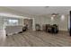 Open living and dining area with laminate flooring throughout at 13479 Newport Ave, Port Charlotte, FL 33981