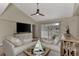 Relaxing living room featuring a sectional sofa, large TV, and access to a patio at 13479 Newport Ave, Port Charlotte, FL 33981