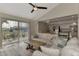 Open living room with sectional sofa and view into the kitchen at 13479 Newport Ave, Port Charlotte, FL 33981