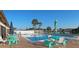 Community pool with teal furniture and umbrellas at 13479 Newport Ave, Port Charlotte, FL 33981