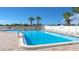 Relaxing community pool with ample lounge chairs and a surrounding patio at 13479 Newport Ave, Port Charlotte, FL 33981