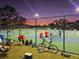 Outdoor tennis courts with players and spectators at sunset at 1667 Laurel St, Sarasota, FL 34236