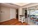 Hallway with wood-look floors and view into sunroom at 2623 Riverbluff Pkwy # 144, Sarasota, FL 34231