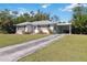 Front view of a single story home with driveway and carport at 3016 14Th W Ave, Bradenton, FL 34205