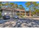 Two-story building with parking and mature trees at 3051 Quail Hollow St # 3051, Sarasota, FL 34235