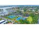 Aerial view of tennis and pickleball courts within a vibrant waterfront community at 312 Yacht Harbor Dr, Osprey, FL 34229