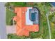 Aerial view of home with red tile roof, screened pool, and landscaped grounds at 312 Yacht Harbor Dr, Osprey, FL 34229