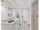 Bright bathroom featuring tiled shower, wood look floors, and a spacious vanity at 312 Yacht Harbor Dr, Osprey, FL 34229