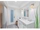 Clean bathroom with white vanity and gray striped shower curtain at 312 Yacht Harbor Dr, Osprey, FL 34229