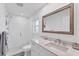 Modern bathroom features a glass shower, a large mirror, and contemporary fixtures and new vanity at 312 Yacht Harbor Dr, Osprey, FL 34229