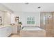 Spa-like bathroom with soaking tub and walk-in shower at 312 Yacht Harbor Dr, Osprey, FL 34229