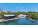 Boat ramp with a covered dock and mangrove trees at 312 Yacht Harbor Dr, Osprey, FL 34229