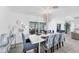 White dining table with blue chairs, and view to the pool at 312 Yacht Harbor Dr, Osprey, FL 34229