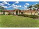 Beautiful home exterior with a red tile roof, manicured lawn, and inviting curb appeal at 312 Yacht Harbor Dr, Osprey, FL 34229