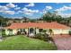 Single-story home with tile roof, landscaping, and a brick driveway at 312 Yacht Harbor Dr, Osprey, FL 34229